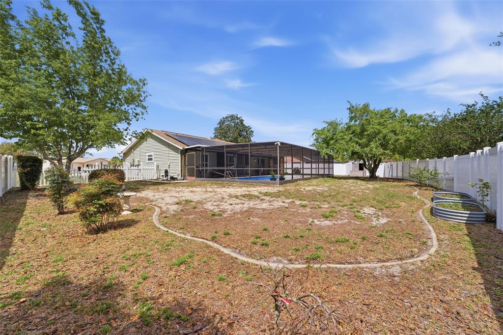 11224 Holbrook Street Spring Hill, FL 34609 - Photo 37 of 55 a backyard of a house with table and chairs