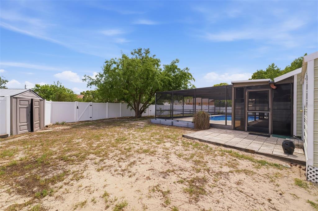 11224 Holbrook Street Spring Hill, FL 34609 - Photo 39 of 55 a backyard of a house with yard and outdoor seating