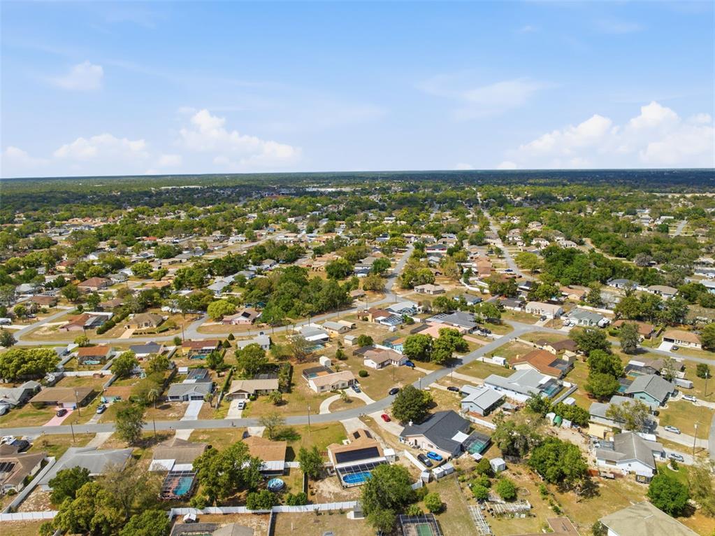 11224 Holbrook Street Spring Hill, FL 34609 - Photo 51 of 55 an aerial view of residential houses with outdoor space