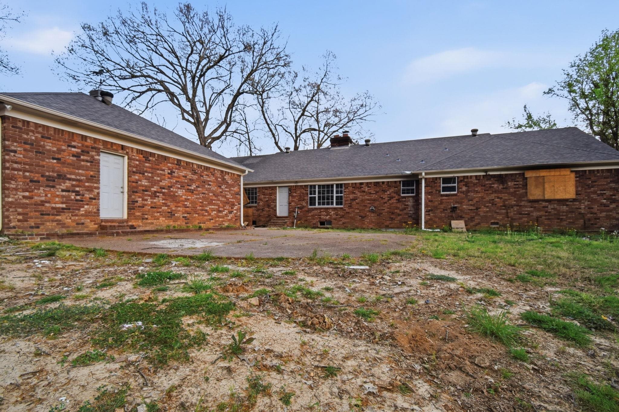 3960 James Road Memphis, TN 38128 - Photo 4 of 4 Back of house featuring a chimney, a patio, brick siding, and roof with shingles