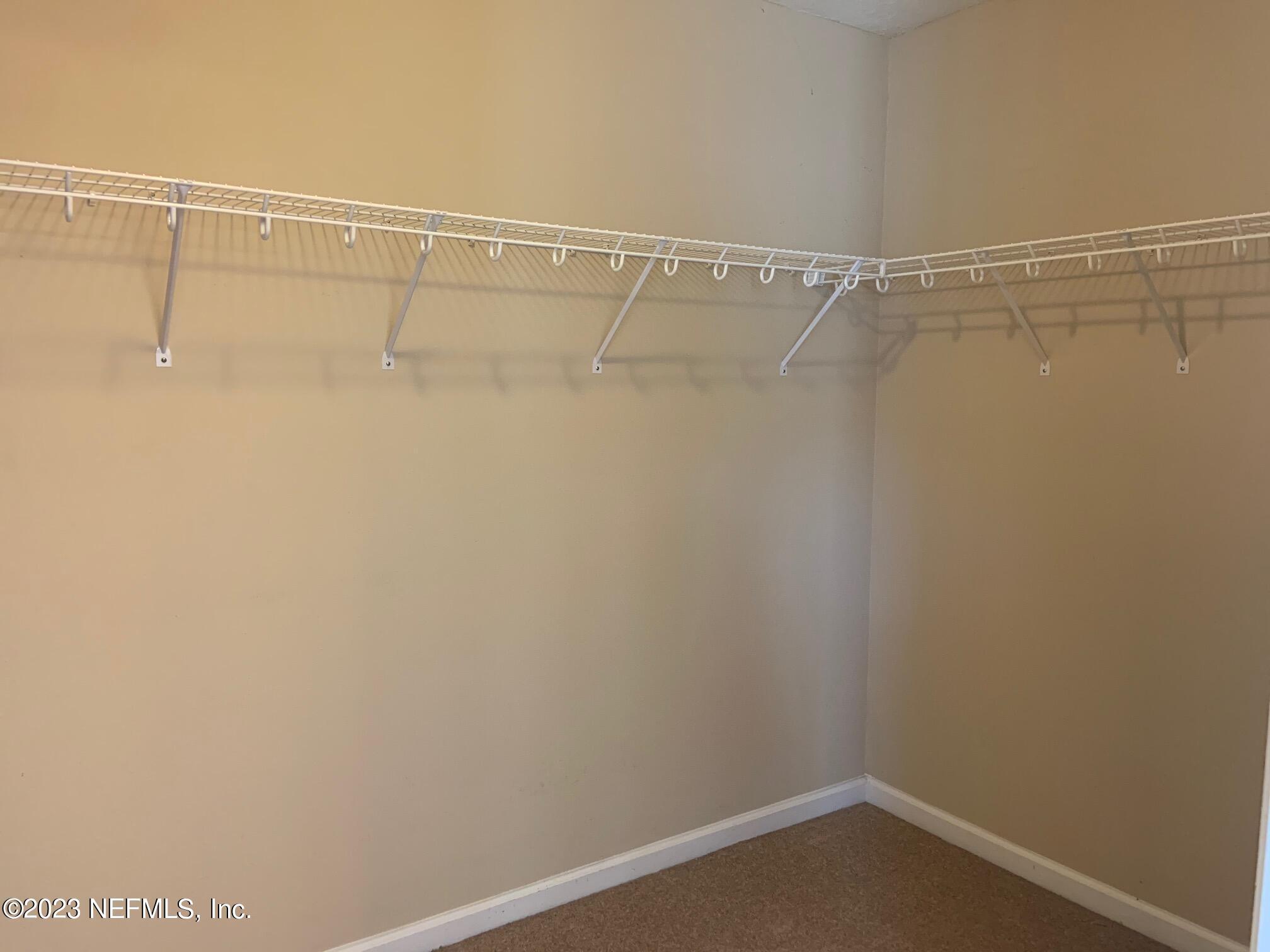 3863 Chasing Falls Road Orange Park, FL 32065 - Photo 24 of 32 a view of a room with racks on the wall