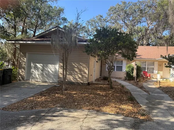 a view of a house with street next to a road