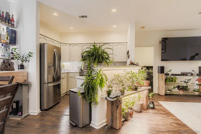 a view of counter top space with refrigerator and microwave