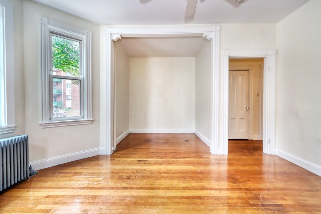 15-17 Pond Street Boston, MA 02130 - Photo 11 of 21 a view of an empty room with wooden floor and a window