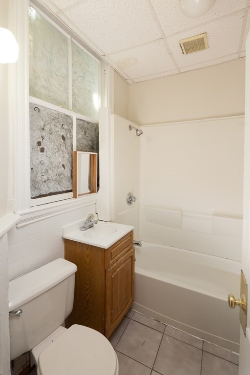 15-17 Pond Street Boston, MA 02130 - Photo 20 of 21 a bathroom with a toilet sink and mirror