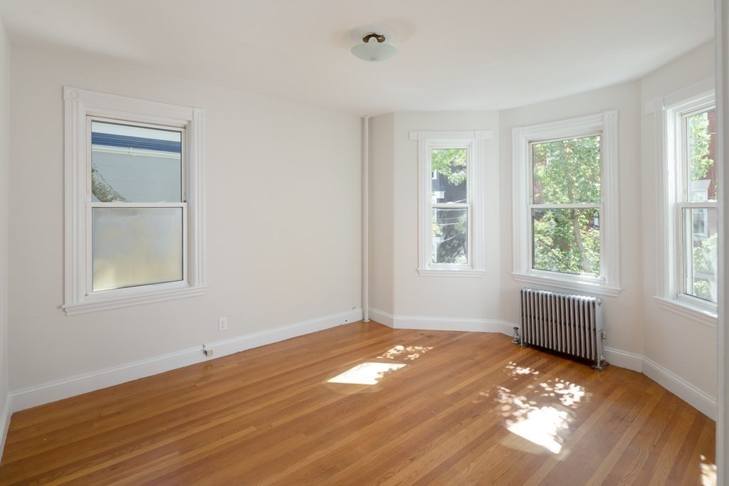 15-17 Pond Street Boston, MA 02130 - Photo 21 of 21 a view of empty room with wooden floor and fan