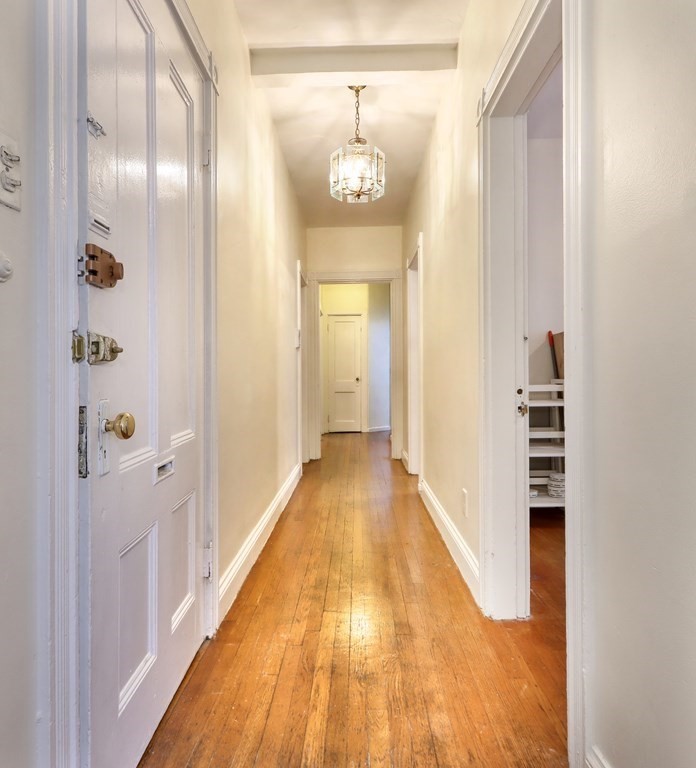 15-17 Pond Street Boston, MA 02130 - Photo 9 of 21 a view of a hallway view with wooden floor and staircase
