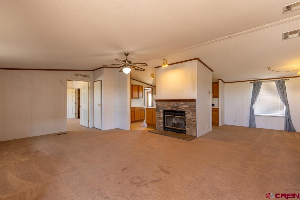 10662 Highway 172 Ignacio, CO 81137 - Photo 22 of 30 a view of an empty room with a fireplace and a window