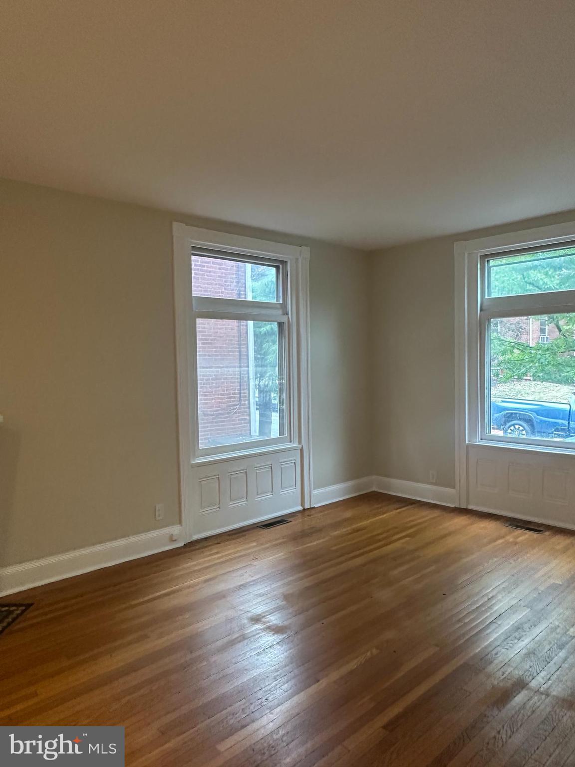 1306 West 13th Street, Unit 1 Wilmington, DE 19806 - Photo 12 of 21 a view of an empty room with wooden floor and a window