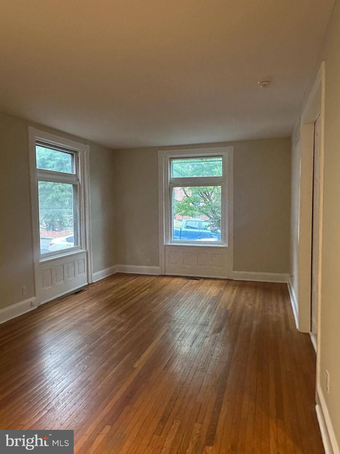 1306 West 13th Street, Unit 1 Wilmington, DE 19806 - Photo 13 of 21 an empty room with wooden floor and windows