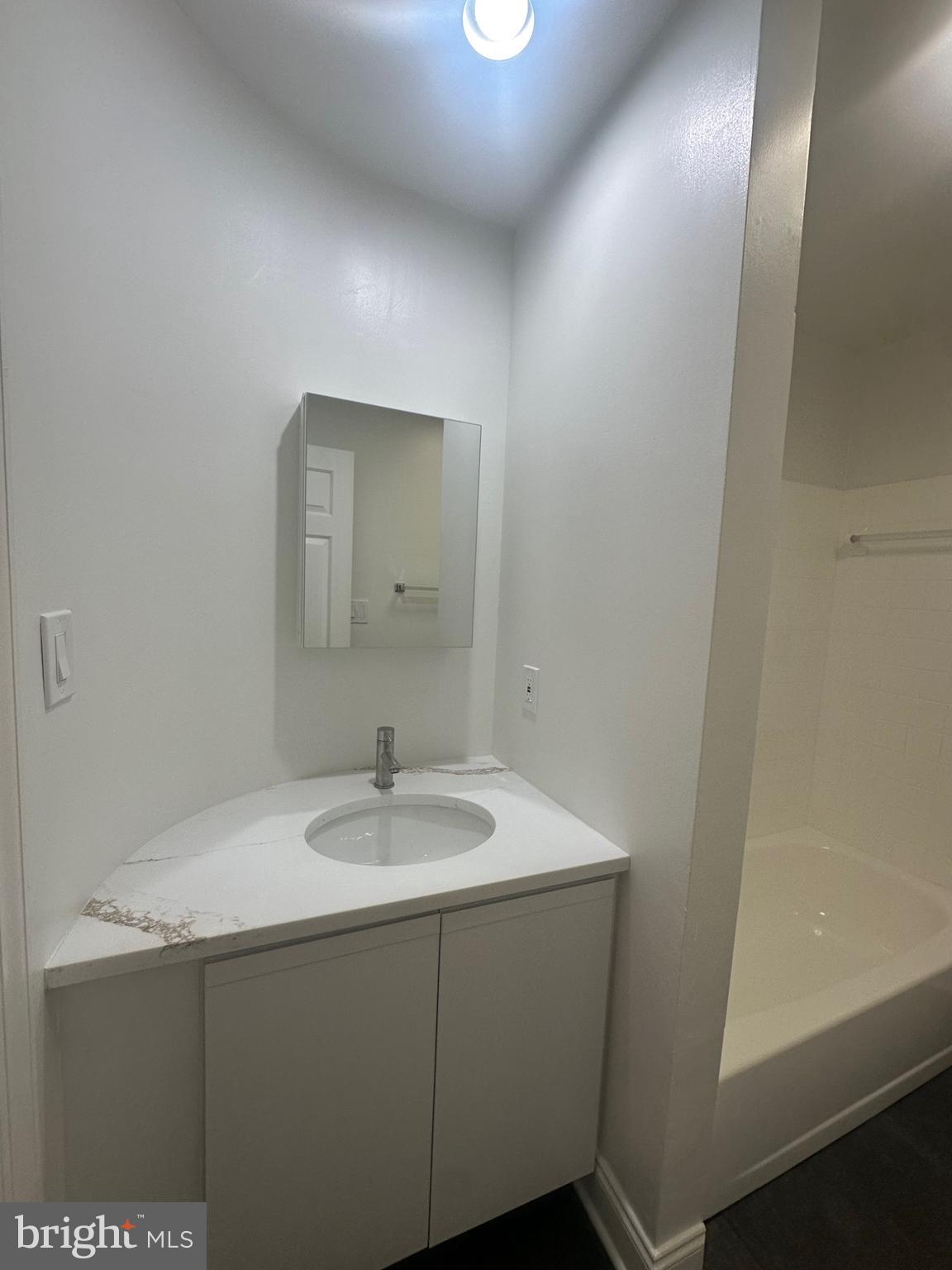 1306 West 13th Street, Unit 1 Wilmington, DE 19806 - Photo 16 of 21 a bathroom with a sink and a mirror