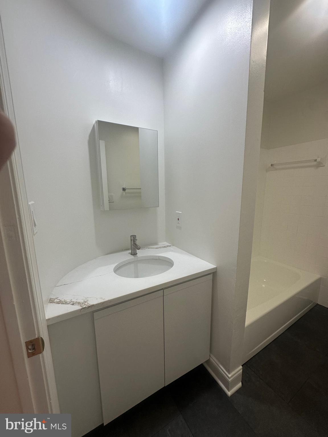 1306 West 13th Street, Unit 1 Wilmington, DE 19806 - Photo 17 of 21 a bathroom with a sink and a mirror