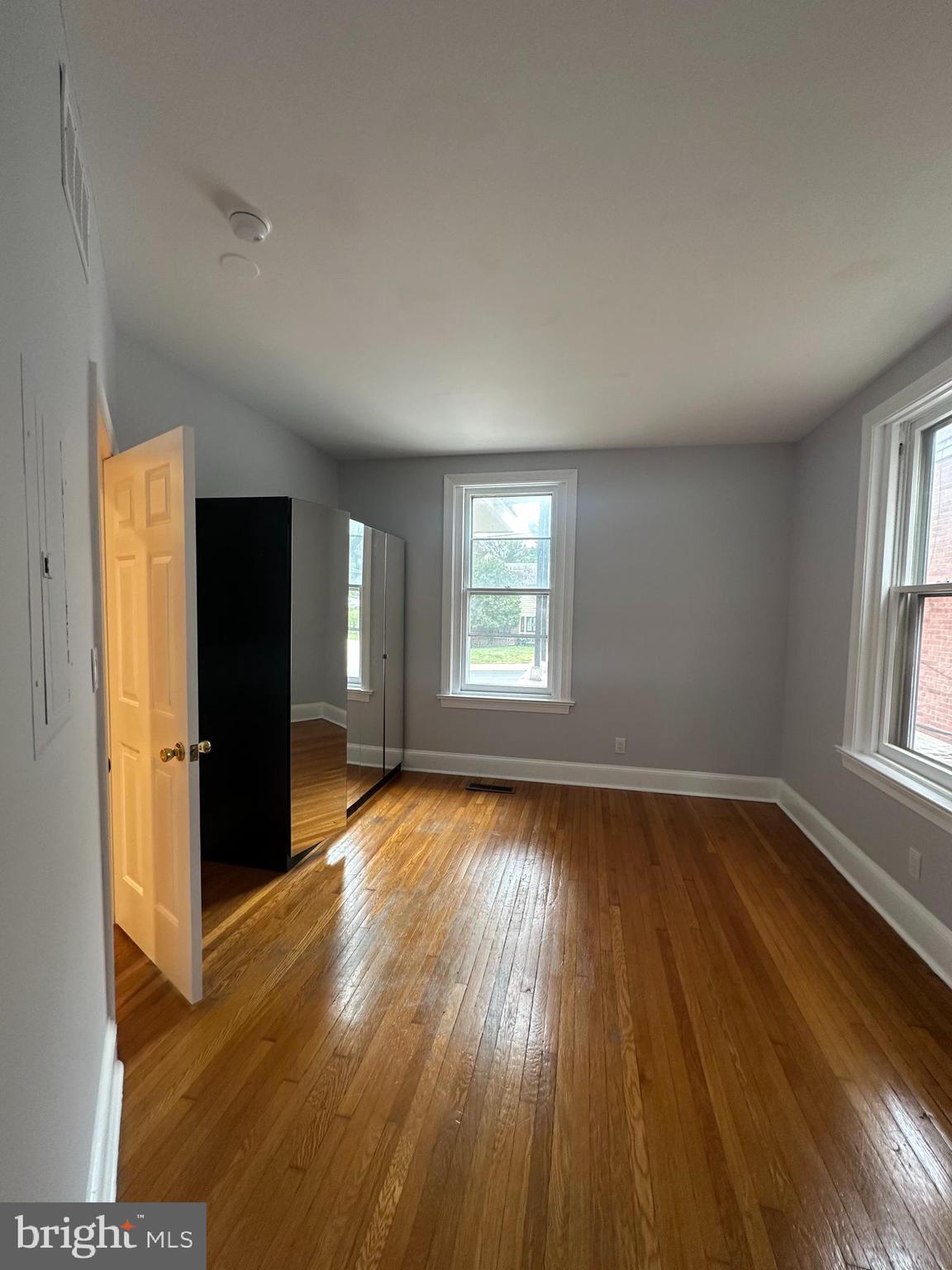 1306 West 13th Street, Unit 1 Wilmington, DE 19806 - Photo 6 of 21 an empty room with wooden floor and windows