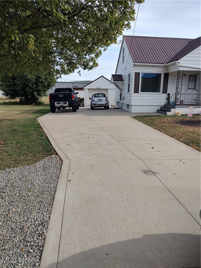 5434 East State Road Newcomerstown, OH 43832 - Photo 4 of 34 View of home's exterior with concrete driveway which provides plenty of parking!