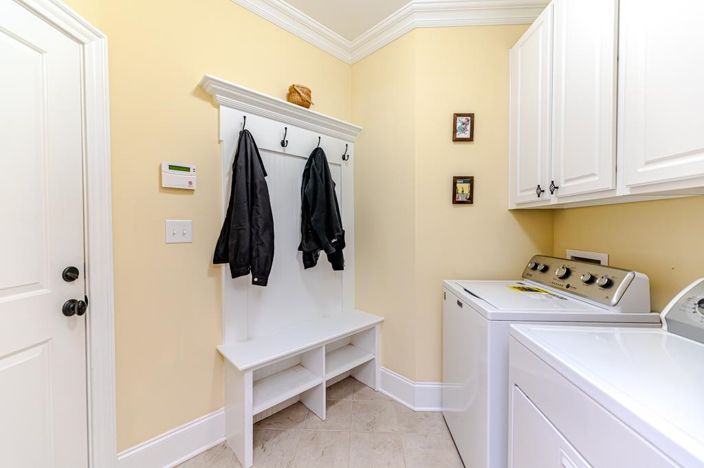 225 Henrys Ridge Road Pittsboro, NC 27312 - Photo 33 of 67 Laundry has drop zone area & cabinets great for storage.