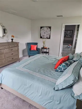 a bedroom with furniture and a dresser