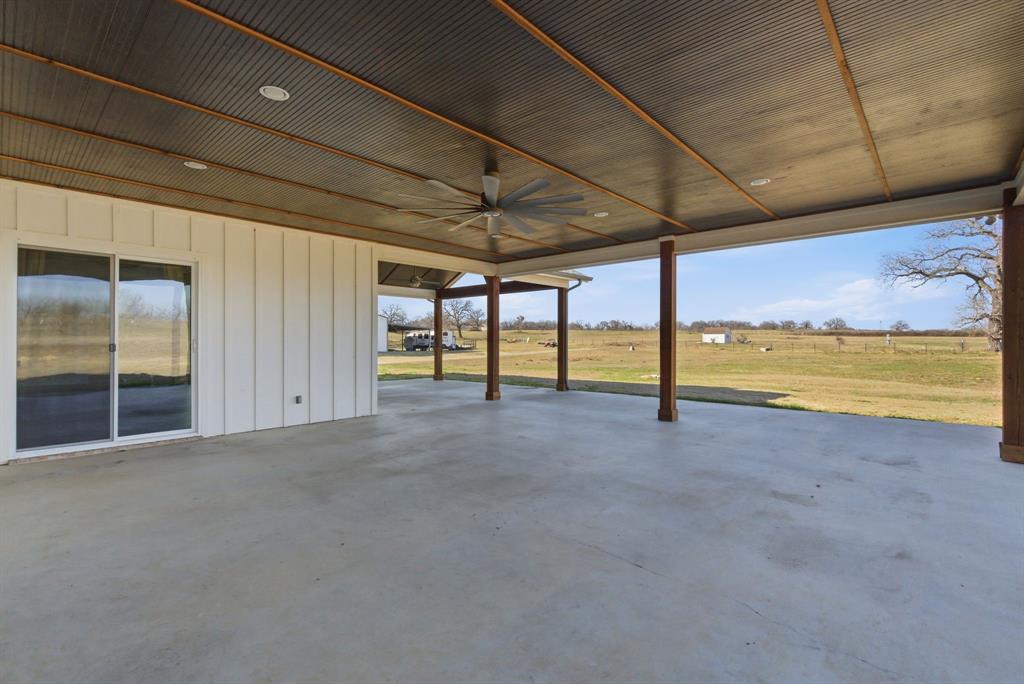 4600 Old Brock Road Weatherford, TX 76087 - Photo 32 of 37 Expansive covered patio featuring a corrugated metal ceiling with recessed lighting, a ceiling fan, and substantial support columns