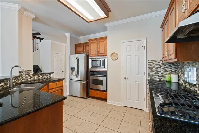 a view of an entryway with wooden floor and a chandelier fan