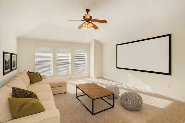 a living room with furniture a lamp and a chandelier