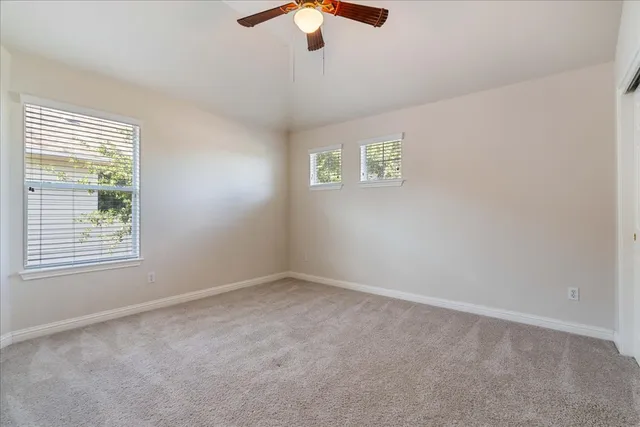 a view of empty room with ceiling fan