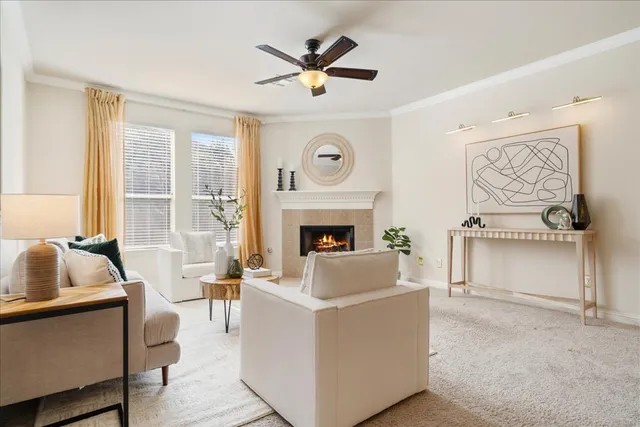 a living room with furniture a fireplace and a flat screen tv