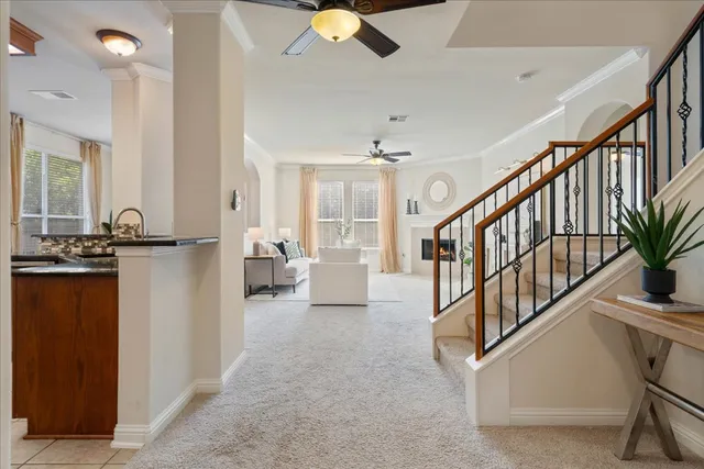 a living room with furniture a fireplace and a large window