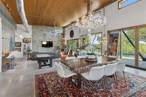 a living room with furniture and a floor to ceiling window