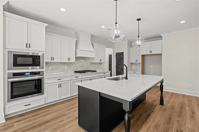 a kitchen with a stove a sink and a refrigerator