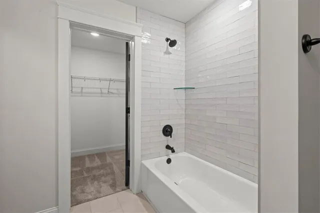 a bathroom with a bathtub and shower