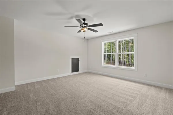 a view of a livingroom with a ceiling fan and window