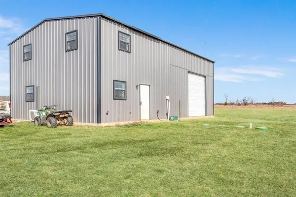 a living room with furniture ceiling fan and a window