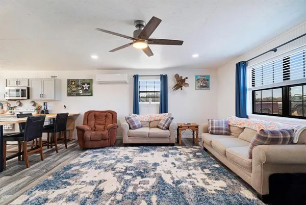 a living room with fireplace furniture and a flat screen tv