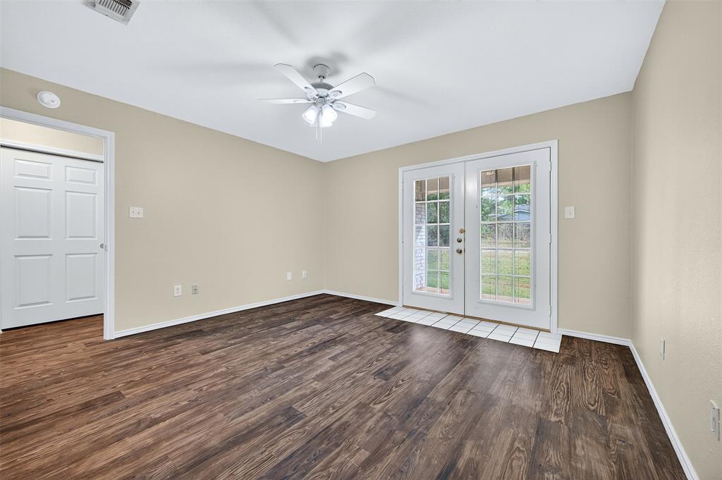 1813 Park Place Sherman, TX 75092 - Photo 13 of 23 a view of an empty room with wooden floor and a window