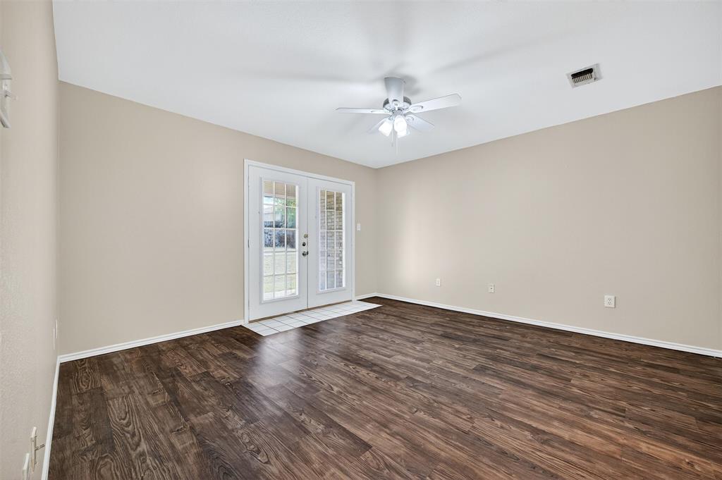 1813 Park Place Sherman, TX 75092 - Photo 14 of 23 a view of an empty room with wooden floor and a window