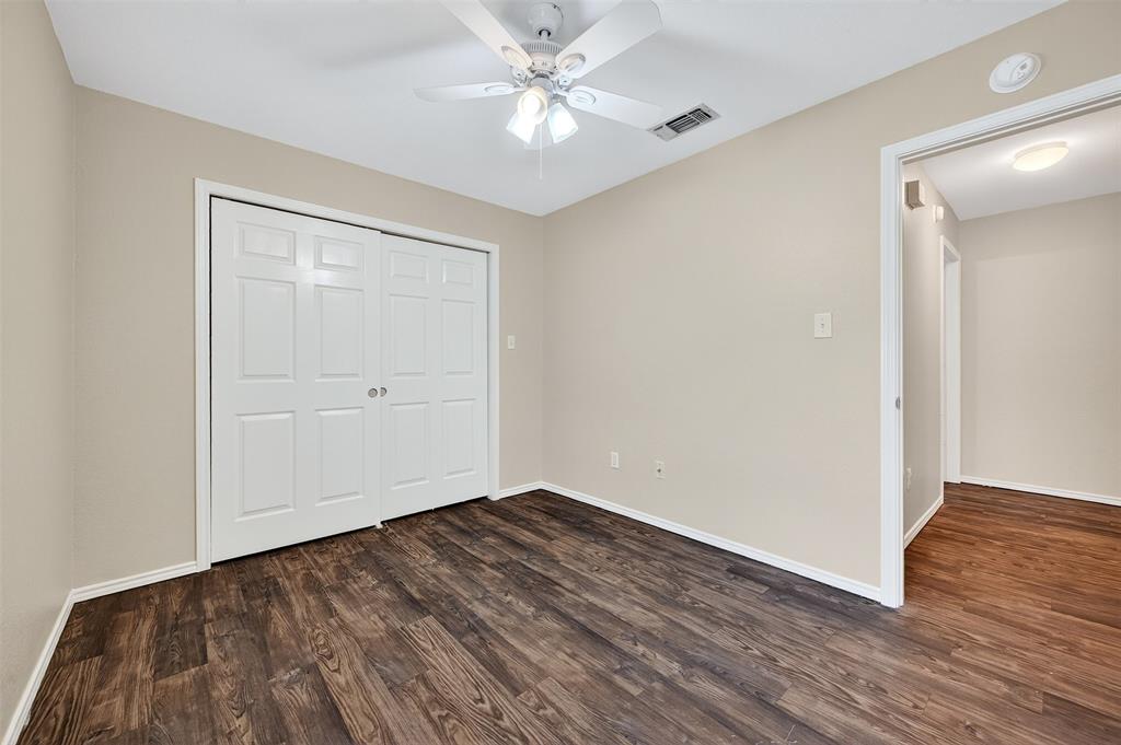 1813 Park Place Sherman, TX 75092 - Photo 21 of 23 a view of a big room with wooden floor and a ceiling fan