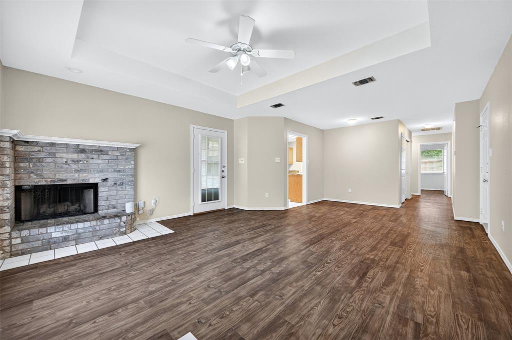 1813 Park Place Sherman, TX 75092 - Photo 4 of 23 a view of an empty room with wooden floor fireplace and a window