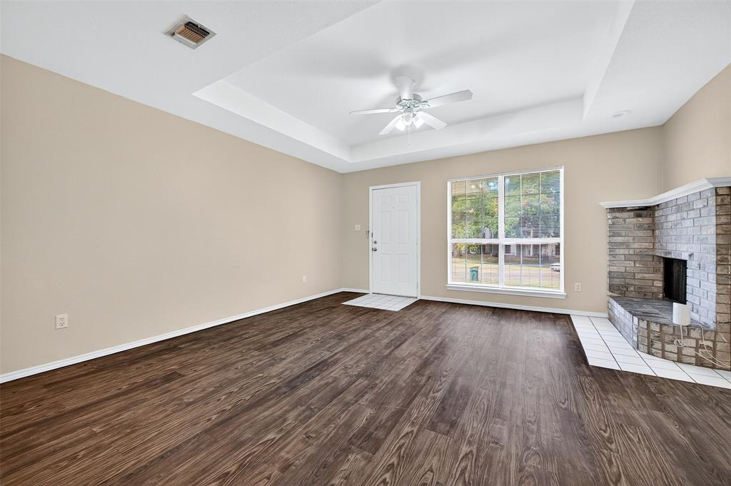 1813 Park Place Sherman, TX 75092 - Photo 6 of 23 wooden floor in an empty room with a fireplace