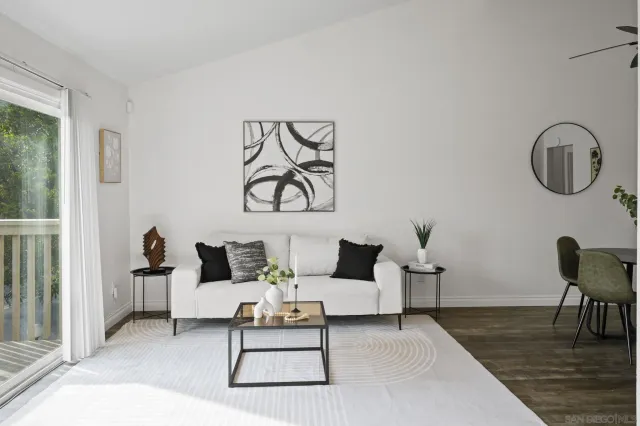 a living room with furniture and white walls