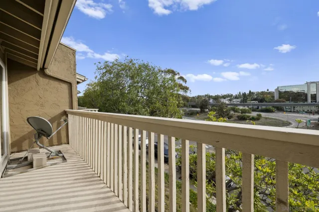 a view of a balcony with chair and wooden floor