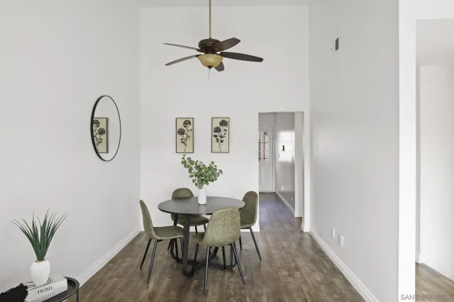 a view of a dining room with furniture and a chandelier