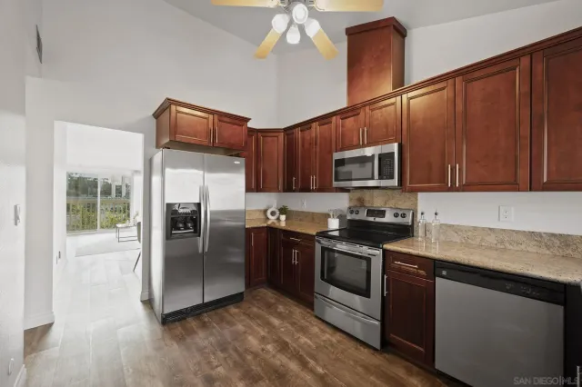 a kitchen with wooden cabinets and stainless steel appliances