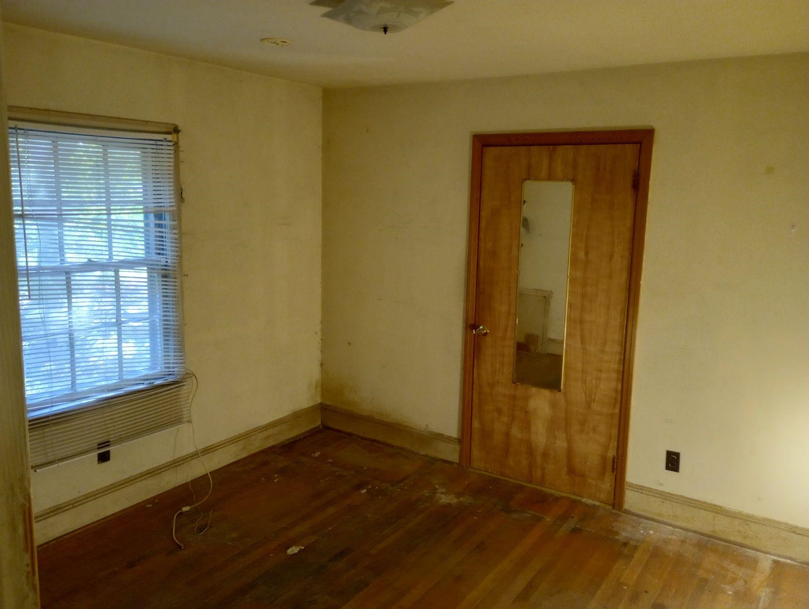 1304 East Jones Street Raleigh, NC 27610 - Photo 11 of 13 an empty room with wooden floor and windows
