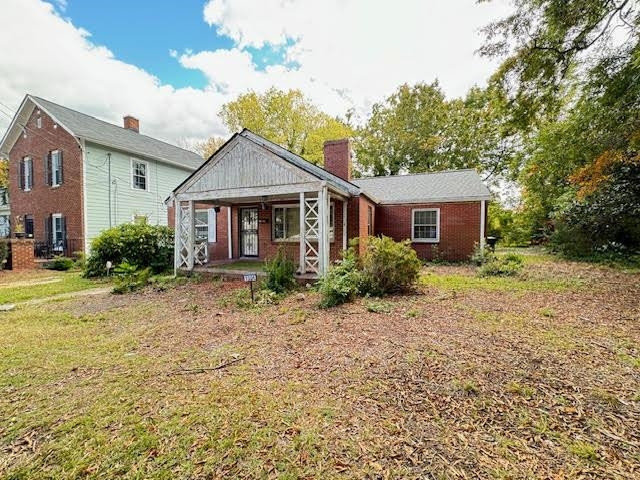 1304 East Jones Street Raleigh, NC 27610 - Photo 4 of 13 a house with trees in the background