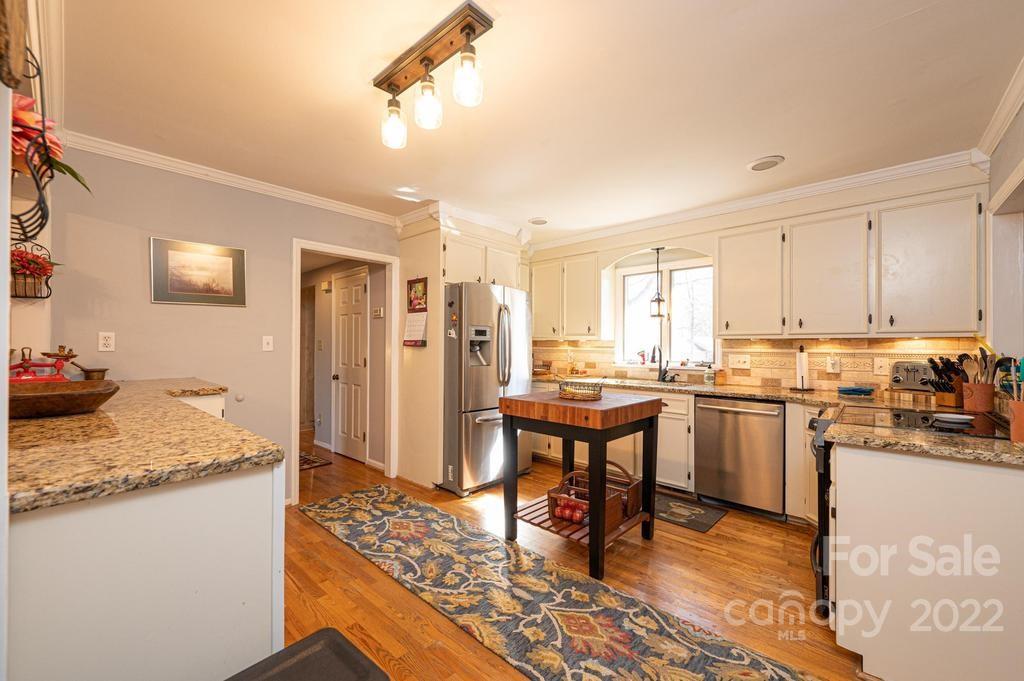 1761 4th St Circle Northeast Hickory, NC 28601 - Photo 23 of 48 a open kitchen with stainless steel appliances granite countertop a stove refrigerator and cabinets
