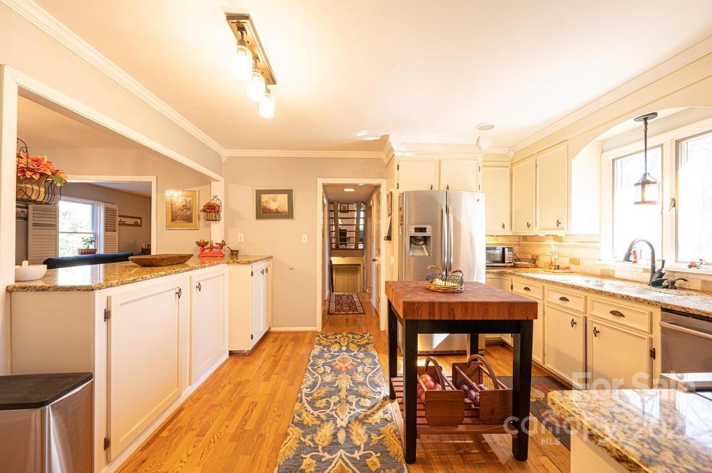1761 4th St Circle Northeast Hickory, NC 28601 - Photo 24 of 48 a kitchen with stainless steel appliances granite countertop a stove and white cabinets