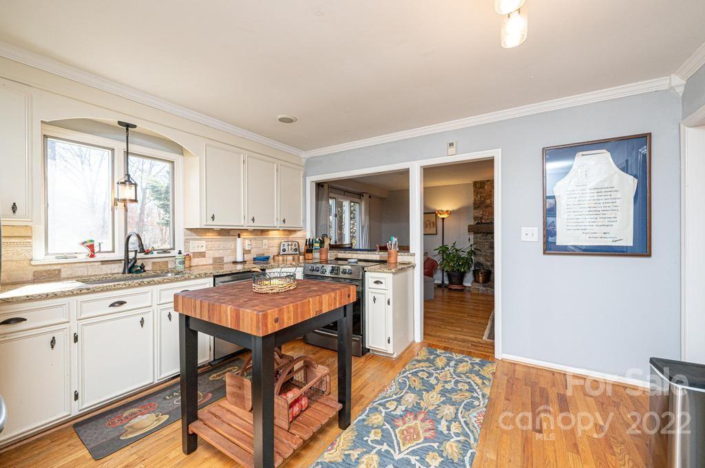 1761 4th St Circle Northeast Hickory, NC 28601 - Photo 26 of 48 a kitchen with stainless steel appliances granite countertop sink stove and cabinets