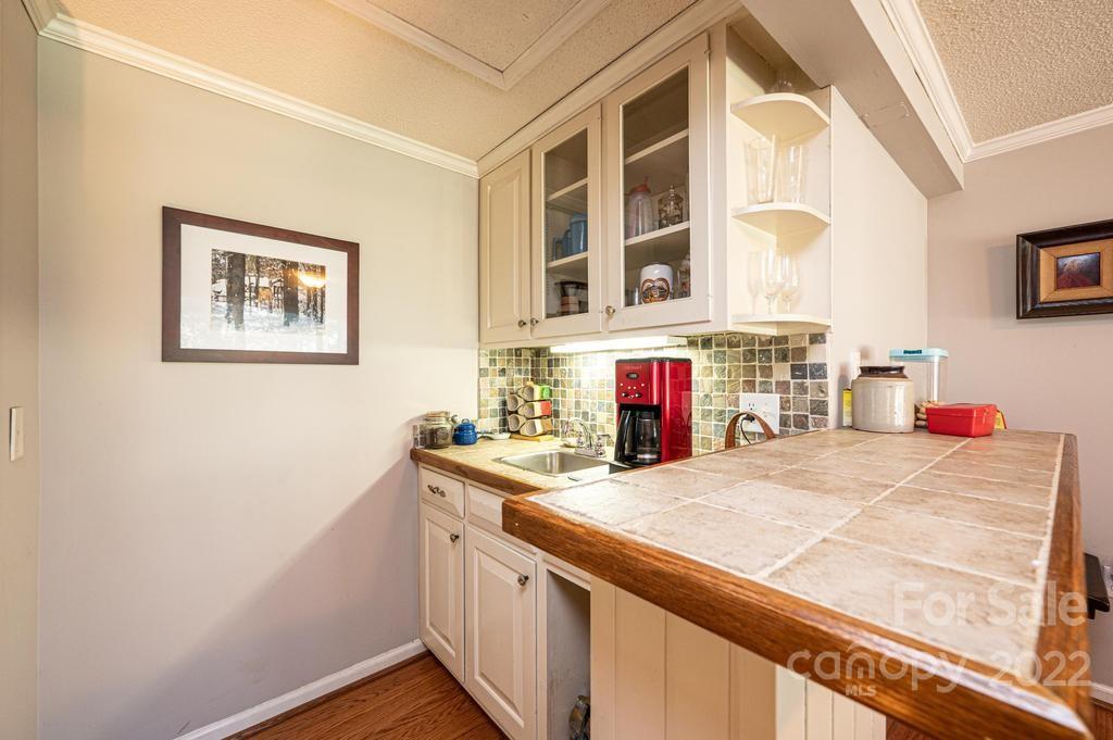 1761 4th St Circle Northeast Hickory, NC 28601 - Photo 34 of 48 a kitchen with a sink stove and cabinets