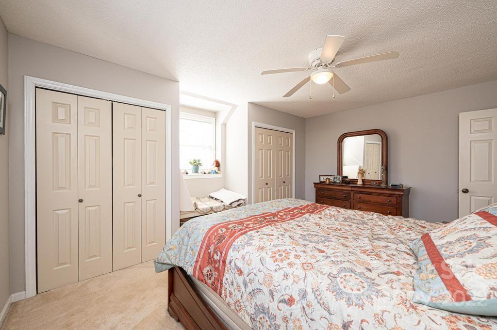 1761 4th St Circle Northeast Hickory, NC 28601 - Photo 41 of 48 a bedroom with a large bed and a chandelier