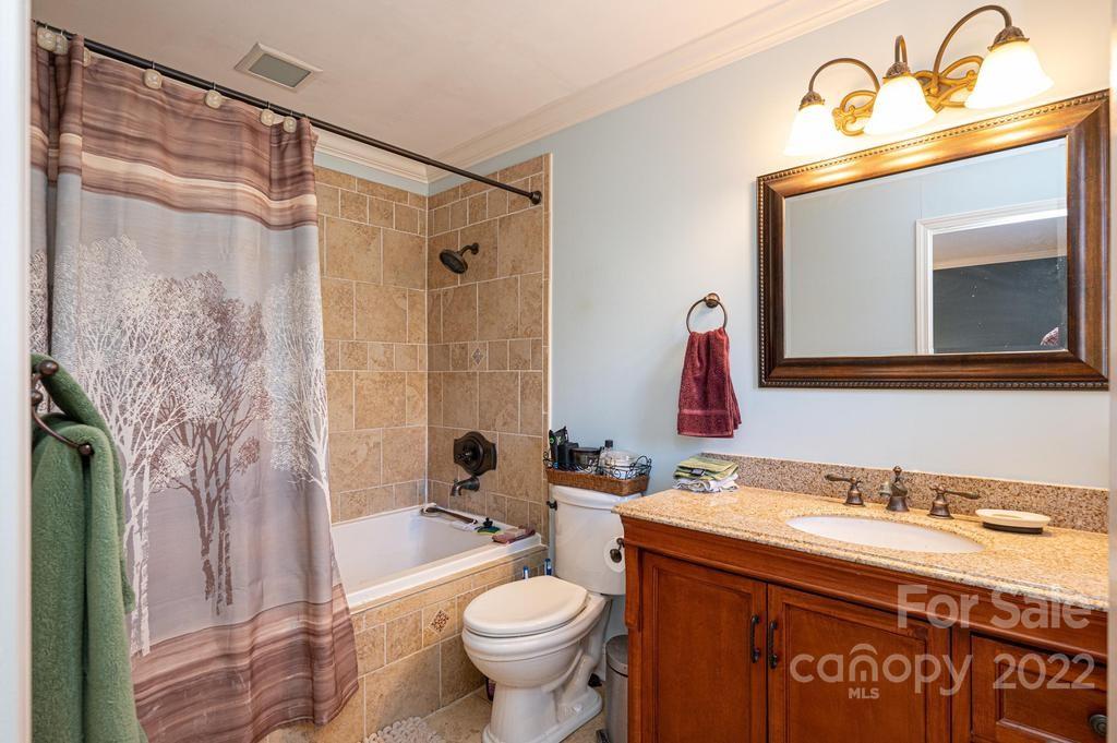 1761 4th St Circle Northeast Hickory, NC 28601 - Photo 44 of 48 a bathroom with a granite countertop sink toilet and shower