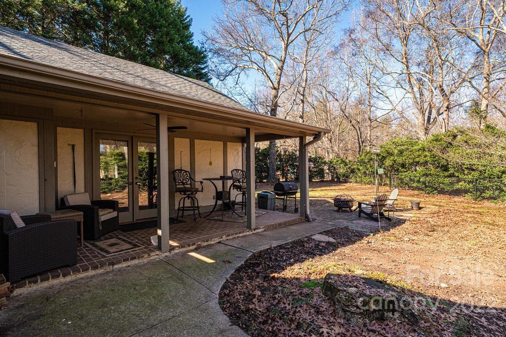 1761 4th St Circle Northeast Hickory, NC 28601 - Photo 10 of 48 a view of a patio with table and chairs under an umbrella with large trees